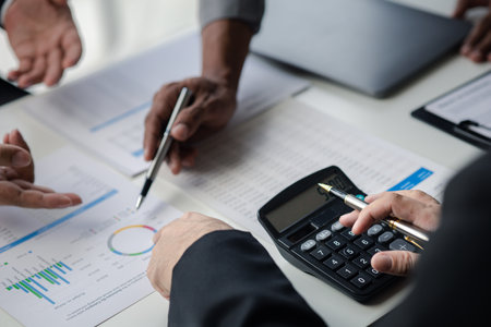 Meeting room atmosphere, business people meeting together on finance topics, they are working together to plan and solve corporate finance issues. Concept of business administration and finance.の写真素材