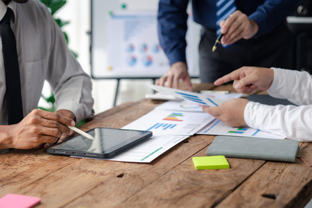 The sales department is having a monthly summary meeting to bring it to the department manager, they are verifying the correctness of the documents that are prepared before bringing in to the managerの写真素材