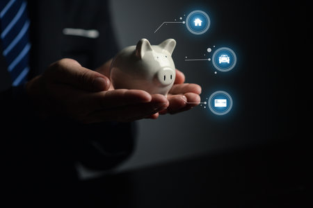 A person is holding a piggy bank, saving money and managing personal finances. Concept of increasing savings and savings by investing in stock mutual funds.の写真素材