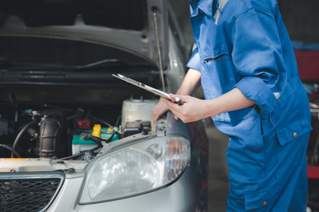 Professional mechanics are helping to check the customer's repair information that is brought to repair, all kinds of car experts, expert car repairs and standardized car repair centers.の写真素材