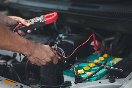Professional mechanic checking customer's car's electrical system brought in for repair, all types of auto specialists, expert car repairs and certified auto repair centers.の写真素材
