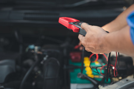 Professional mechanic checking customer's car's electrical system brought in for repair, all types of auto specialists, expert car repairs and certified auto repair centers.の写真素材