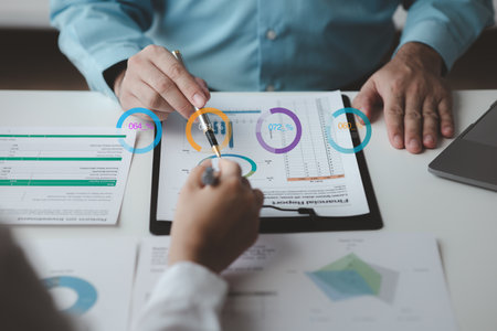 Businessman is reviewing monthly sales documents for analysis and marketing plans for more sales growth, they are the founders of young companies co-founding startups. Sales management concept.の写真素材