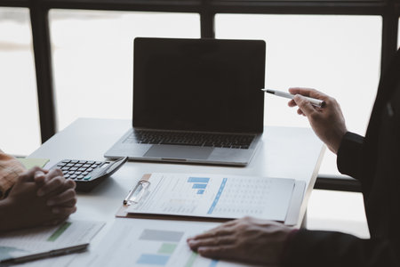 Atmosphere of a startup company meeting, business people are meeting together to summarize and plan investment finances, they are the founders of the company. Business administration concept.の写真素材