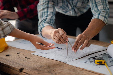 The home design architects are reviewing the house plan draft, the project commissioned by the...