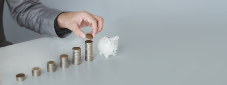 Person with pile of coins and piggy bank, money saving concept for future use and financial...