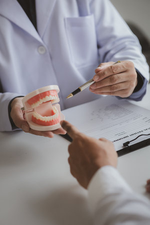 Dentists are providing dental treatment consultations to patients undergoing dental pain treatment,...