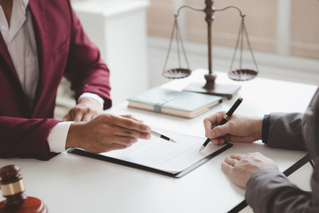 Attorneys advising in cases where a client has been defrauded by a defendant who is a business partner forming a joint company, advising on litigation and gathering evidence. Fraud case concept.の写真素材