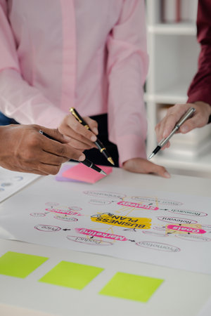 Company meeting room has businessmen and finance managers meeting together on business plan, they are looking at information on documents and discussing together. Concept business planning management.の写真素材