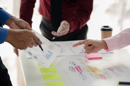 Company meeting room has businessmen and finance managers meeting together on business plan, they are looking at information on documents and discussing together. Concept business planning management.の写真素材