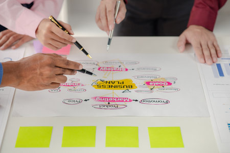 Company meeting room has businessmen and finance managers meeting together on business plan, they are looking at information on documents and discussing together. Concept business planning management.の写真素材