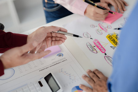 The sales department is having a monthly summary meeting to bring it to the department manager, they are verifying the correctness of the documents that are prepared before bringing in to the manager.の写真素材