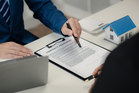 Real estate agents explain models of housing estates in projects to elaborate to clients, explaining and presenting information about homes and purchasing loans. Real estate trading concept.の写真素材