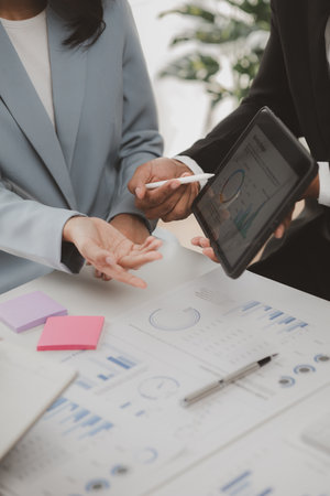 Group businessmen are reviewing monthly sales documents for analysis and marketing plans for more sales growth, they are the founders of young companies co-founding startups. Sales management concept.の写真素材