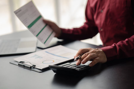 A financier is reviewing company financial documents, monthly financial statement summary from the finance department. The concept of managing the company's finances for accuracy and growth.の写真素材