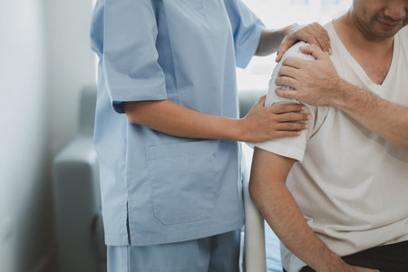 A physiotherapist doing physiotherapy for a patient in a hospital room, physiotherapy helps to recover from illness by moving the body and muscles. The concept of treating illnesses with physical therapy.の写真素材