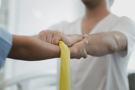 Physiotherapist is doing physical therapy for a patient, the patient has body aches due to overwork and has undergone treatment and physiotherapy with a professional physiotherapist.の写真素材