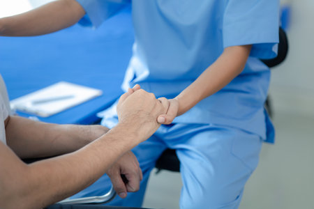 Male patient sitting in wheelchair undergoing a medical examination with specialist physician, treating injuries Getting medical treatment from specialist doctor can get the right and proper treatmentの写真素材