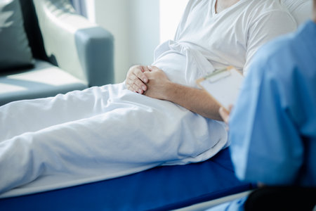 Patient on an inpatient hospital bed with a doctor examining and asking for information about the symptoms in order to diagnose the correct and appropriate treatment. The concept of medical treatment.の写真素材