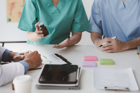 A conference room in a hospital where a group of doctors are attending a meeting, a meeting of executive doctors and chiefs meeting with pharmaceutical dealers. Doctor meeting concept.の写真素材