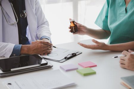 A conference room in a hospital where a group of doctors are attending a meeting, a meeting of executive doctors and chiefs meeting with pharmaceutical dealers. Doctor meeting concept.の写真素材