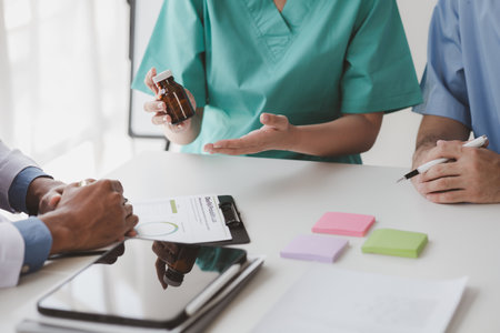 A conference room in a hospital where a group of doctors are attending a meeting, a meeting of executive doctors and chiefs meeting with pharmaceutical dealers. Doctor meeting concept.の写真素材