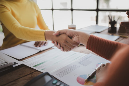 Business investor group shakes hands, Two businessmen are agreeing on business together and shaking hands after a successful negotiation. Handshaking is a Western greeting or congratulation.の写真素材