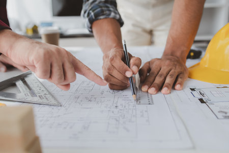 The home design architects are reviewing the house plan draft, the project commissioned by the client, and the custom design before delivery. Interior design and decoration ideas.の写真素材