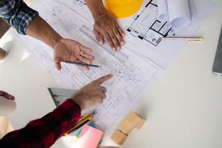 The home design architects are reviewing the house plan draft, the project commissioned by the client, and the custom design before delivery. Interior design and decoration ideas.の写真素材
