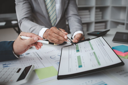 Atmosphere of a startup company meeting, business people are meeting together to summarize and plan investment finances, they are the founders of the company. Business administration concept.の写真素材