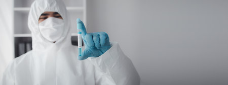 Lab practitioner working on chemical research for chemical reactions, does a chemical experiment and examines a patient's blood sample. Medicine and research concept.の写真素材