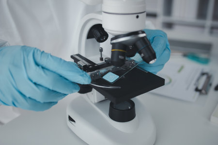 Lab practitioner working on chemical research for chemical reactions, does a chemical experiment and...