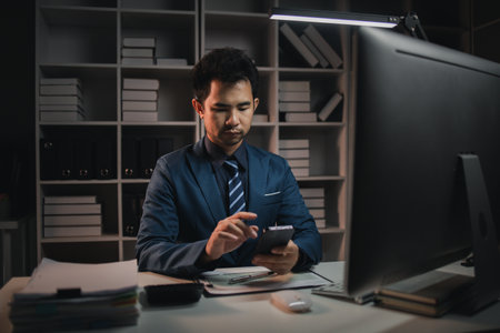 The male employee is in the office in the middle of the night. Overtime concept. Employees of private companies.の写真素材