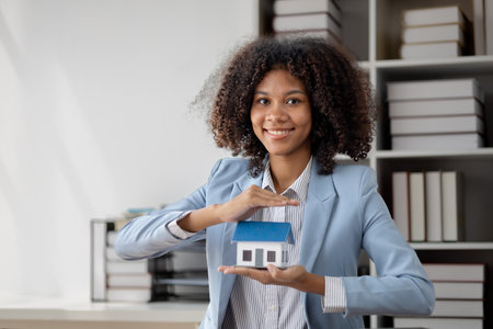 An American woman is a land and real estate broker for houses and condos, she is a real estate broker recommending houses to clients. Real estate trading concept.の写真素材