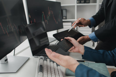 Two stock investors with stock market graph screen, stock fluctuation analysis, business man trading...