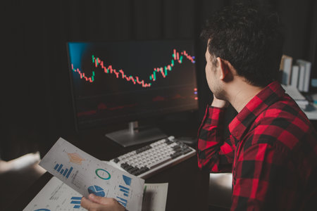 Stock investor with stock market graph screen, stock fluctuation analysis, business man trading stocks for profit, stock market fluctuation graph screen, profit trading analysis.の写真素材