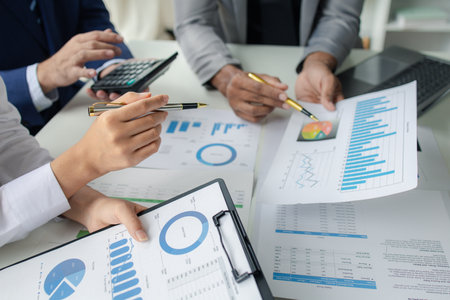 Atmosphere of a startup company meeting, business people are meeting together to summarize and plan investment finances, they are the founders of the company. Business administration concept.の写真素材