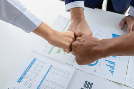 A group of startup businessmen joining hands, business meetings, startup company sales team meetings, brainstorming and summary of company performance. Business strategy management concept.の写真素材