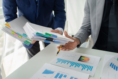 Atmosphere of a startup company meeting, business people are meeting together to summarize and plan...