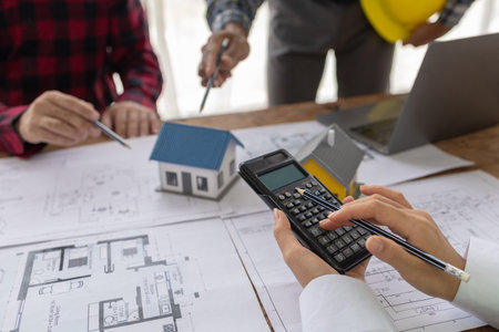 Interior designers and engineers and architects work together to plan the construction of the house...