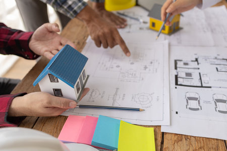 Interior designers and engineers and architects work together to plan the construction of the house...