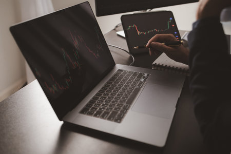 Person looking at stock chart, businessman stock investor trading stocks, stock market analysis for profitable trading, investing in cryptocurrencies. Concept of investing in stocks.の写真素材