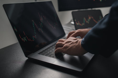Person typing on laptop keyboard keys, stock investor businessman trading stocks, stock market analysis for profitable trading, cryptocurrency investment. Concept of investing in stocks.の写真素材