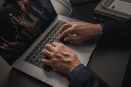 Person typing on laptop keyboard keys, stock investor businessman trading stocks, stock market...