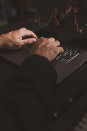 Person typing on laptop keyboard keys, stock investor businessman trading stocks, stock market analysis for profitable trading, cryptocurrency investment. Concept of investing in stocks.の写真素材