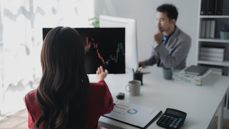 Asian woman looking at stock market graph screen, stock market businessman analyzing stock market rise and fall chart, stock market investor, profit making. investment concept.の写真素材
