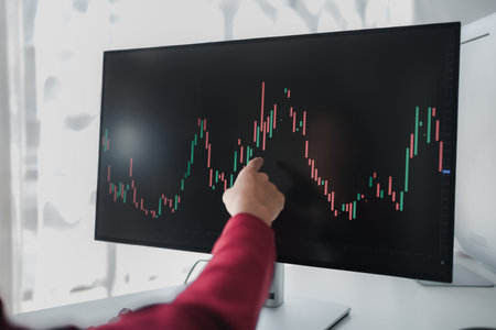 Asian woman looking at stock market graph screen, stock market businessman analyzing stock market rise and fall chart, stock market investor, profit making. investment concept.の写真素材