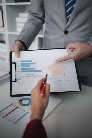 Two businessmen are discussing analyzing company financial papers, operating and marketing planning...