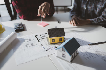 The home design architects are reviewing the house plan draft, the project commissioned by the client, and the custom design before delivery. Interior design and decoration ideas.の写真素材