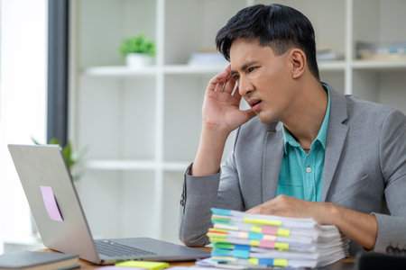 Startup businessman working and having body aches due to hard work, office syndrome, company...